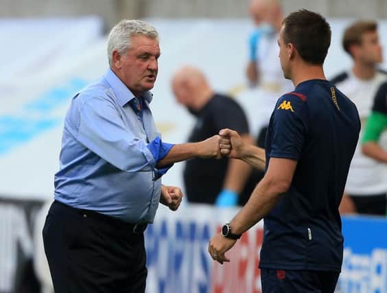 Newcastle United's English head coach Steve Bruce (L) bumps fist with Aston Villa's English assistant manager John Terry (R) at the end of the game during the English Premier League football match between Newcastle United and Aston Villa at St James' Park in Newcastle-upon-Tyne, north east England on June 24, 2020.