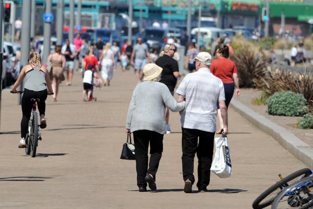A couple pictured having a walk in the sun at Seaburn while socially distancing.