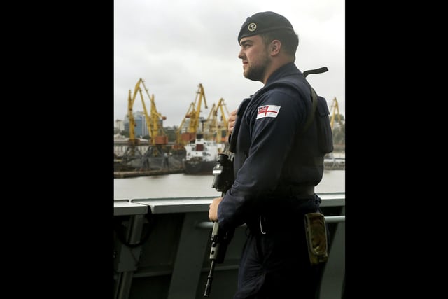 A Royal Navy Gunner stands guard on the upper deck as HMS Dragon sails into Odessa, Ukraine. Just days after entering the Black Sea HMS Dragon arrives in Odessa in preparation to play a key role in multi-international training objectives.