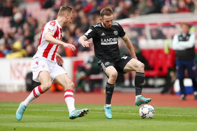 Rhys Norrington-Davies of Sheffield United under pressure from Ben Wilmot of Stoke City during the Sky Bet Championship match at the Bet365 Stadium: Cameron Smith/Getty Images