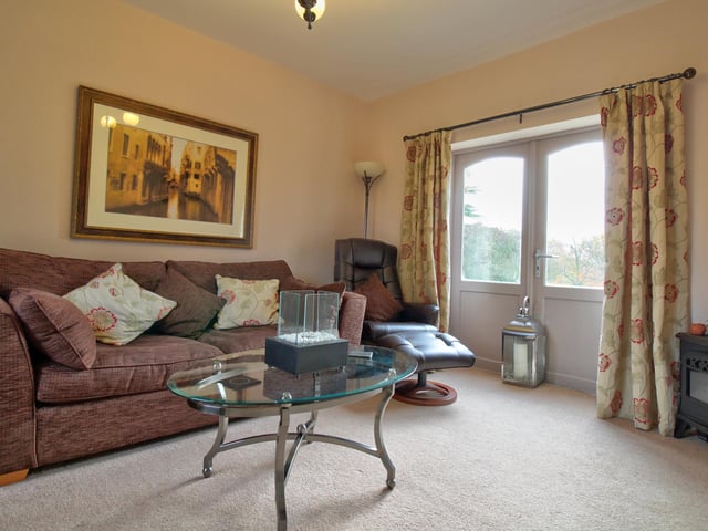 With double doors providing access to the front of the property, window to the rear elevation and wall mounted radiator.