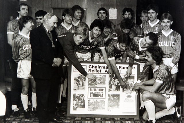 Chesterfield players make their contribution to the chairman of Derbyshire County Council's famine relief appeal. Councillor Joe Carty is pictured with members of the first-team squad in November 1984.
