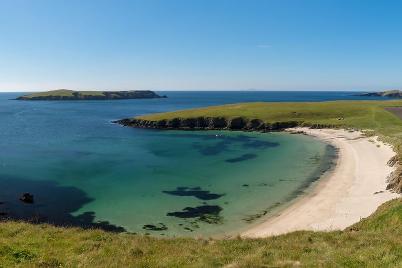 The gloriously white beach of Scousburgh Sands is backed by dunes and rolling countryside and is considered Shetland's finest strand.