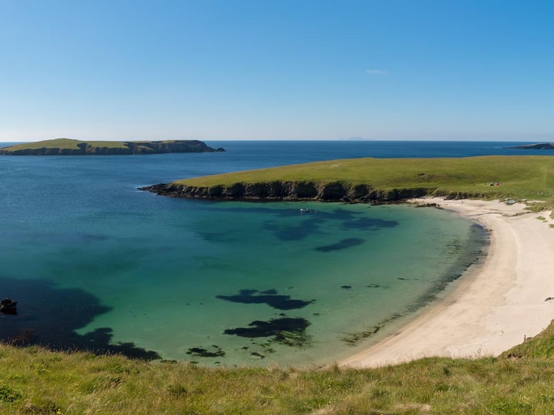 The gloriously white beach of Scousburgh Sands is backed by dunes and rolling countryside and is considered Shetland's finest strand.