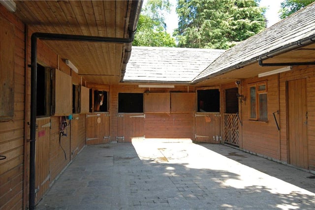 The extensive grounds also include a purpose-built stable block and a large paddock.