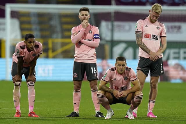 Oli McBurnie of Sheffield Utd (R) reacts after missing a penalty during the Carabao Cup match at Turf Moor, Burnley: Andrew Yates/Sportimage