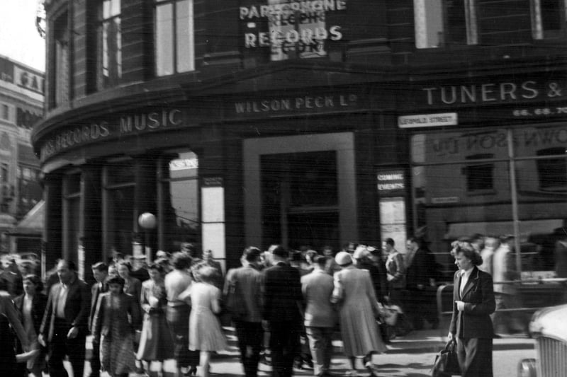 Shoppers crossing Leopold Street in 1952, with the A Wilson Peck and Co Ltd Music Warehouse in the background. Picture Sheffield reference number s17613