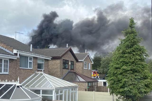 Thick black smoke was seen billowing up over houses by witnesses who live on the road.