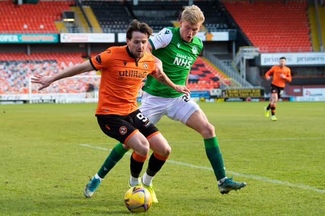 Marc McNulty tries to hold off Josh Doig as the pair battle for the ball at Tannadice