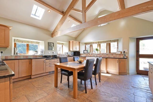 The breakfast kitchen and utility room have an exposed ceiling with oak roof timbers, a stone flagged floor, dual aspect windows, added natural light from skylights, along with a stable style door to a further garden terrace. There are a range of fitted Shaker style kitchen units.