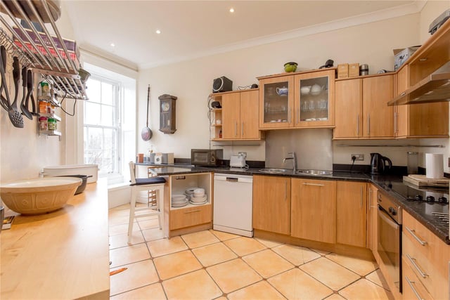 The spacious kitchen has plenty of storage and space for dining.