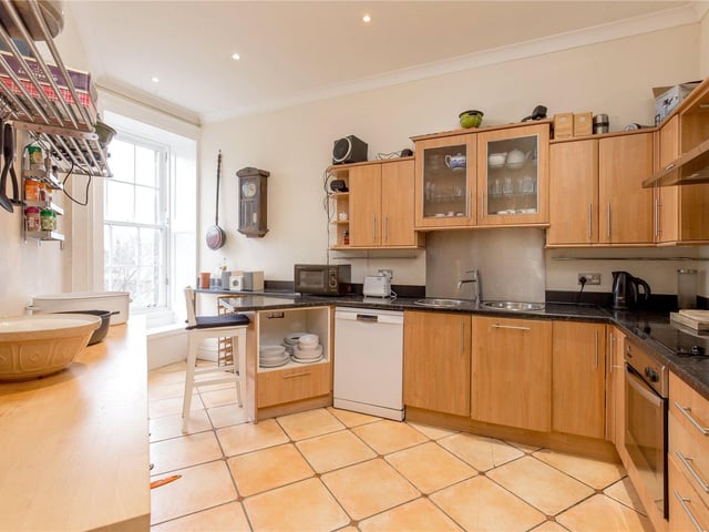The spacious kitchen has plenty of storage and space for dining.