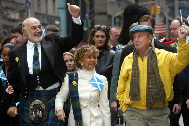 Sean Connery, his wife Micheline Roquebrune and New York City Mayor Michael Bloomberg wave to the crowd as they march up Sixth Avenue during the world's largest pipe and drum parade to celebrate Scottish Tartan Day April 6, 2002 in New York City. 