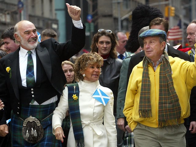 Sean Connery, his wife Micheline Roquebrune and New York City Mayor Michael Bloomberg wave to the crowd as they march up Sixth Avenue during the world's largest pipe and drum parade to celebrate Scottish Tartan Day April 6, 2002 in New York City. 