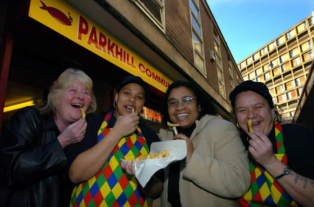 Denise Ford, chair of Park Hill Tennants Association; Alishia Juels, staff; Christine Kamara, secretary of Park Hill Tennants Association; and Dawn Norton, staff, trying out chips at Park Hill Community Fisheries in December 2003
