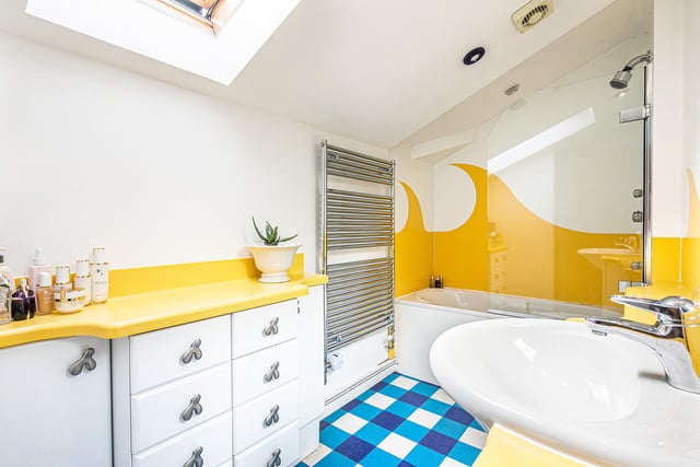 The main bathroom has been painted with a motif of waves in a shade of yellow.