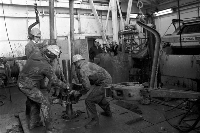 Workers add another section of pipe to the drill at BP's Forties Field oil platform in October 1975.