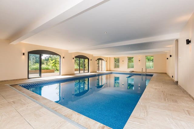 The large indoor swimming pool is approximately 40’x20’ and around 8ft deep with fixed diving board, shower and changing facilities along with sauna room. There are sliding doors with a south facing decked area leading down to a Sarah Murch designed mature planted garden, seating area and bar.