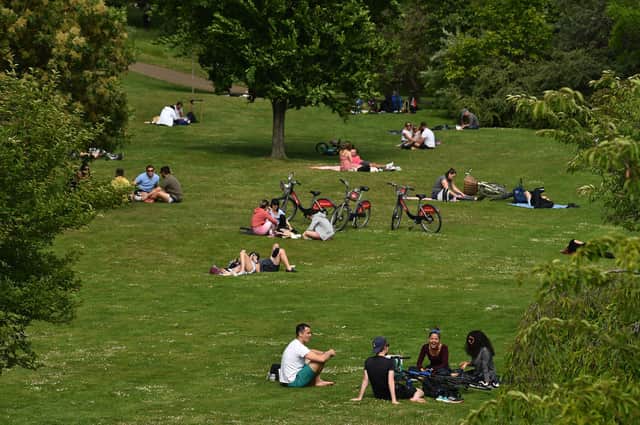 People enjoy the warm Spring temperatures (Photo by Glyn KIRK / AFP) (Photo by GLYN KIRK/AFP via Getty Images)
