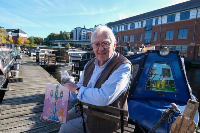 Artist Joe Scarborough working on his latest projects on his boat in Sheffield Canal Basin.