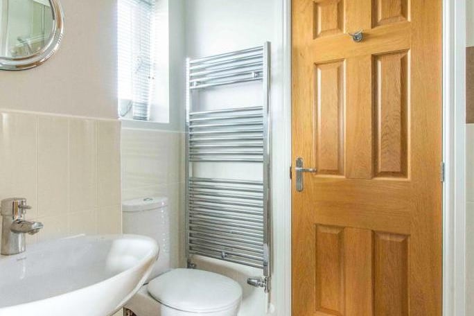 En-Suite Jack And Jill  - Fitted with a WC, a wash hand basin with mixer tap and a thermostatic shower with tile surround. There are spotlights to the ceiling, an extractor fan, a shaving point and a chrome heated towel rail. With a side facing frosted double glazed window.