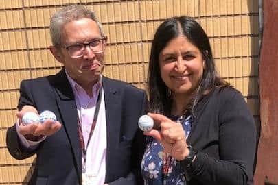 Dr Andrew Farrell, Matt Fitzpatrick's former English teacher, and Harkiran Grewal, his former history teacher,  with the golf balls the US Open winner signed for them when he left school.