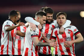 Ben Osborn (right) congratulates Billy Sharp with Ollie Norwood after the Blades skipper's winner against Newcastle United earlier this week (Photo by Stu Forster/Getty Images)