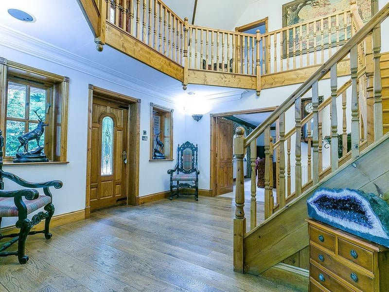 As you enter Loxley Lodge, you are greeted by this spectacular, double-height reception hall, with hardwood flooring. It has a split staircase, leading to a galleried landing.