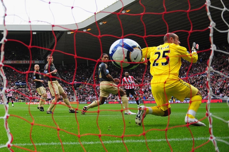 Darren Bent of Sunderland watches as his shot goes between Glen Johnson and Pepe Reina of Liverpool into the goal during the Barclays Premier League match between Sunderland and Liverpool.