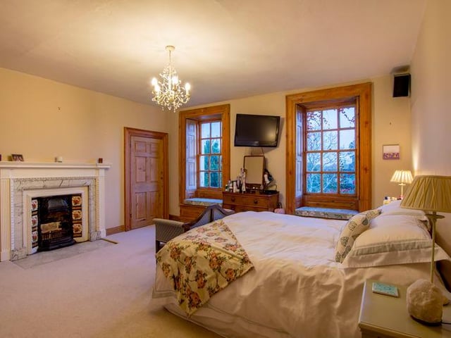 This bedroom has two windows each with window seats.