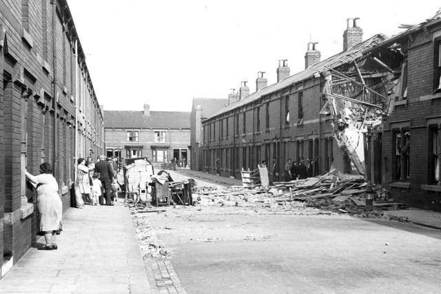 It's August 1940 in Hartlepool and these people are surveying the scene of an air raid in Faulder Road .  A family of seven whose home was partly demolished crawled out without a scratch.