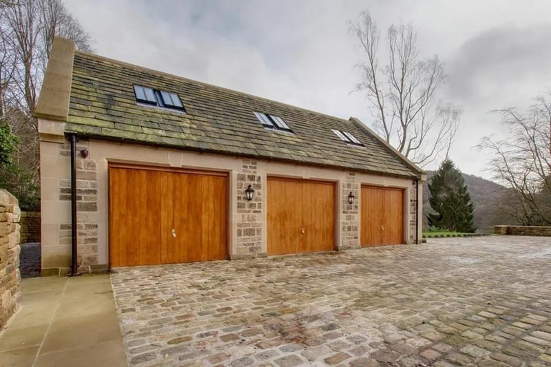 Detached double garage with timber bi-fold doors and part-glazed timber doors with matching side panels give access to the office/study, with stairs to bedroom six and bedroom six ensuite.