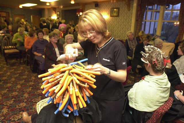 A fund-raising event in aid of Rossington Hall  took place at the Millstone pub, Tickhill in 2001. Our picture shows hair stylist Nikki Barlow  working on fellow hair stylist's Nicky Richards' hair. Both work at the Jasmine Hair Salon, Tickhill.