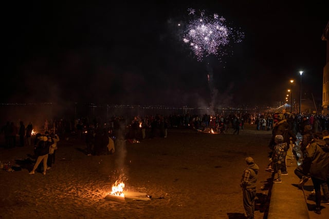 Groups of people watching the fireworks stretched all the way along the beach and the promenade.