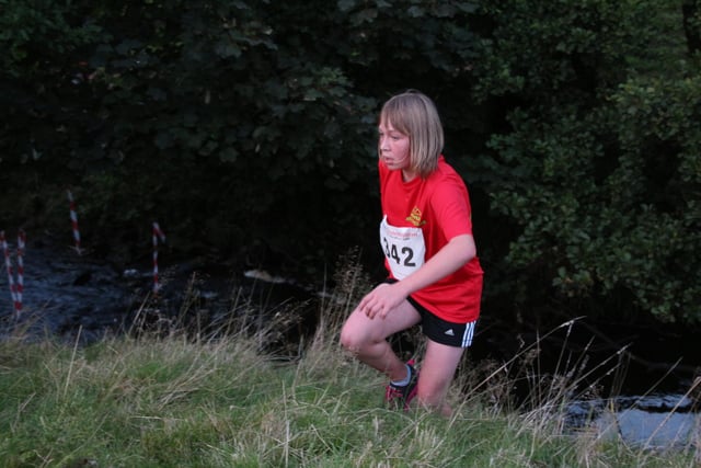 A High Peak Athletics Club member tests herself in a cross country event.