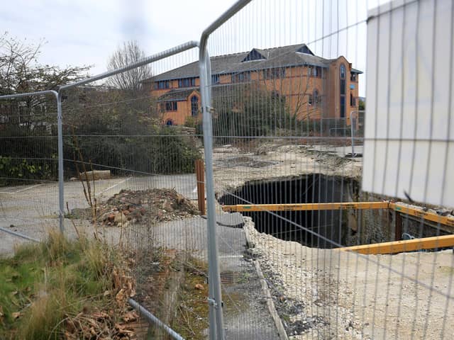 The sink hole that appeared at Decathlon, Sheffield, in the car park. Work is due to be completed on waterways beneath it next year.