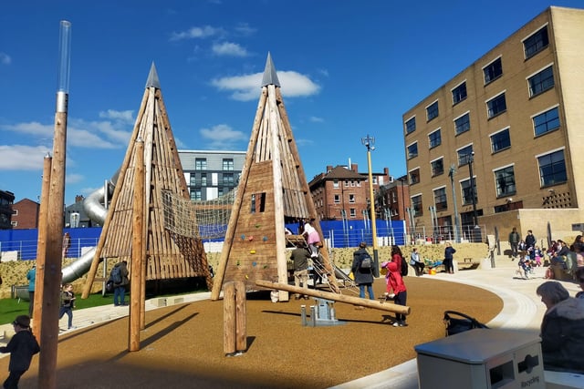 The park includes two distinct towers with slides and a rope bridge, a set of play chimes, sand toys, climbing frames, and the pieces for a yet-to-launch water feature.