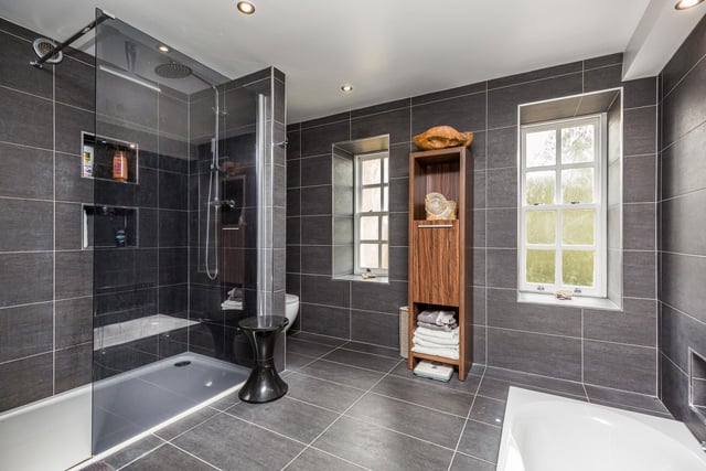 A beautifully appointed fully tiled bathroom suite comprising, double walk in shower, sunken bath with hand held shower over, vanity unit with his/hers sinks, W/C and heated towel rail. Ceiling spot lights, feature lighting and underfloor heating.