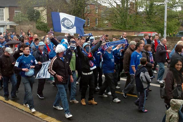 Spireites fans parade through Chesterfield town centre.