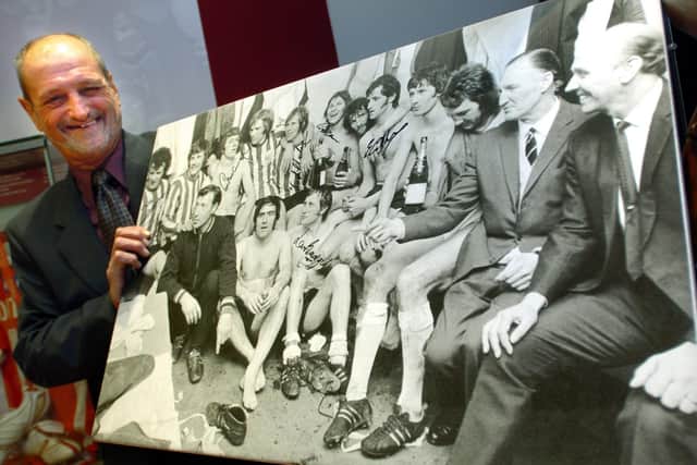 Eddie Colquhoun with a picture of his Sheffield United 1970-71 side celebrating promotion at a reunion dinner at Bramall Lane