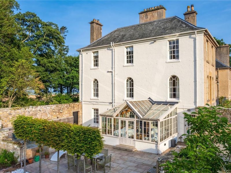 Side of property with conservatory and terrace.