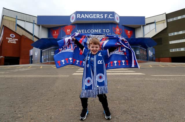 Rangers fan Arlo Low, aged 5, outside of the Ibrox Stadium, home of Rangers FC.