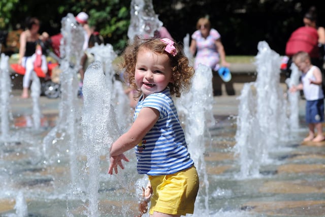 Three-year-old Violet Morris cools off in the fountains in Sheffield's Peace Gardens on June 25, 2018 as temperatures were expected to rise across Yorkshire in the following week