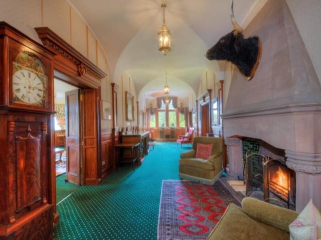 A double arched and glazed entrance doors lead to a vestibule with a marble floor, original oak panelling, arched windows and ornate cornicing