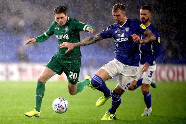 Sheffield Wednesday midfielder Adam Reach (left) has spoken about the club's efforts to bring in targets such as Cardiff's Aden Flint (right).