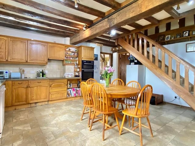 The day begins with breakfast in this homely kitchen. It is fitted with a range of wall and base units, a stainless steel sink and integrated appliances, including a double oven, four-ring ceramic hob and built-in wine-cooler. A staircase rises to the east wing accommodation.