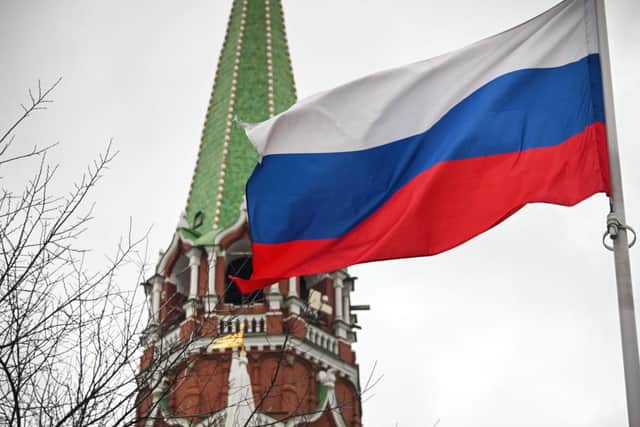 A Russian flag waves next to one of the Kremlin towers in Moscow: ALEXANDER NEMENOV/AFP via Getty Images