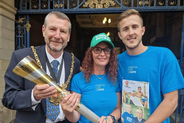 Lord Mayor of Sheffield Colin Ross, Baton of Hope support Jocie Tomman and Sheffield Wednesdays player and charity ambassador Will Vaulks.