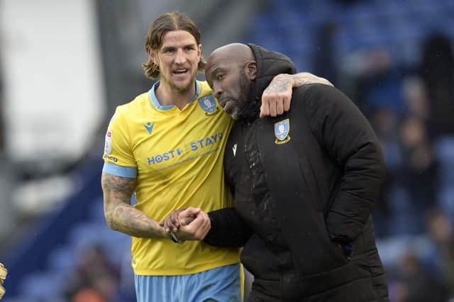 Owls Aden Flint with his manager Darren Moore at the final whistle   PIc Steve Ellis