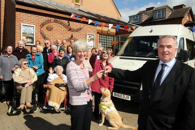 Peter Mcnestry Chairman of the Coalfield regeneration Trust handed over the keys of a new mini bus to Lynn Farebrother Chair of Centre Point in Kirkby in 2010.  Looking on is Olivia  the guide dog  with service users and staff